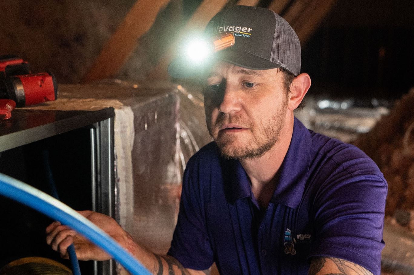 Voyager technician repairing air conditioning unit