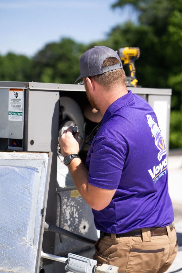Voyager technician carefully protecting a customer's home before beginning a deep duct cleaning